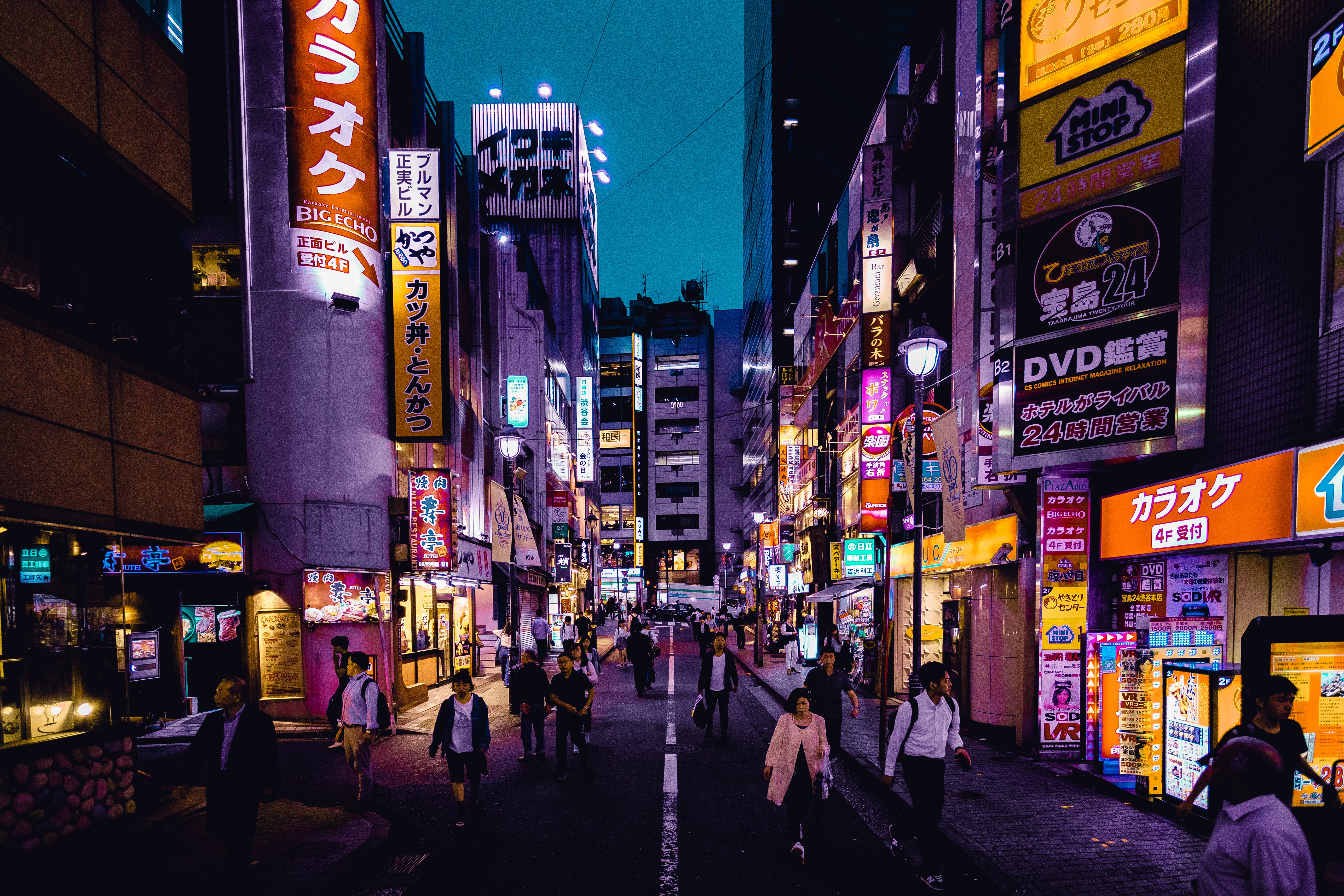 a city street in Japan featuring brightly lit signs.